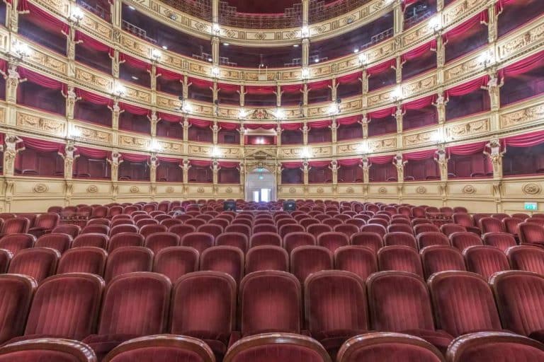 Interior of the Teatro Verdi, red velvet seats in the auditorium, Trieste, Italy.