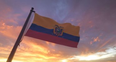 Ecuador Flag on Flagpole by Evening Sunset Sky